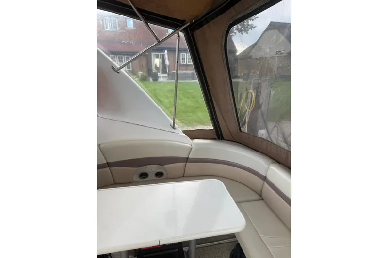 Slide: The Image of 2005 Chaparral Signature 350 interior with seating and table, enclosed by clear panels. - 17