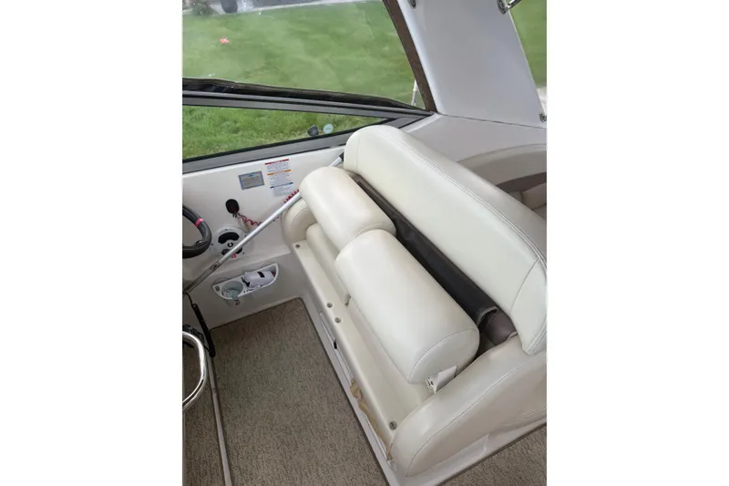 Slide: The Image of 2005 Chaparral Signature 350 boat interior with white leather seating and steering area. - 19