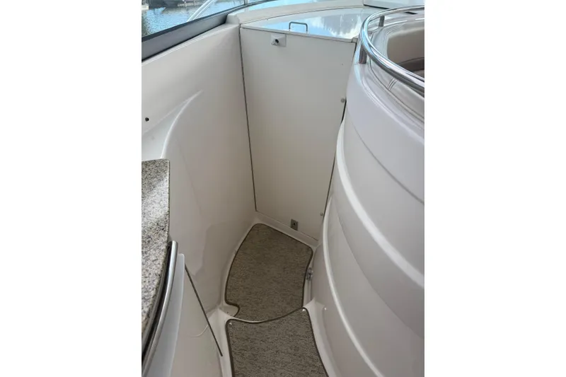 Slide: The Image of 2005 Chaparral Signature 350 boat interior with sleek design and carpeted flooring. - 20