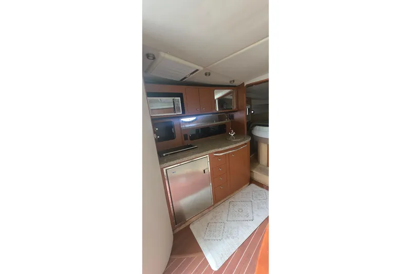 Slide: The Image of 2005 Chaparral Signature 350 yacht interior with kitchenette and modern amenities. - 23