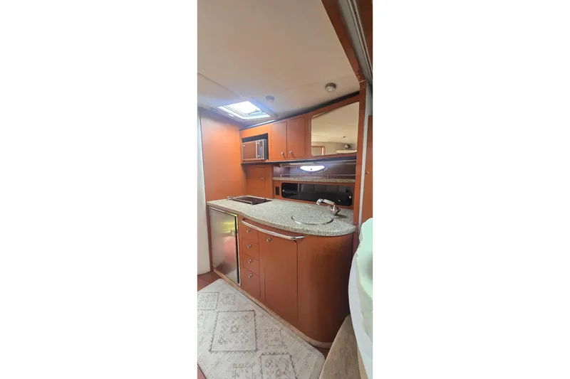 Slide: The Image of 2005 Chaparral Signature 350 yacht interior with modern kitchen and wood cabinetry. - 24