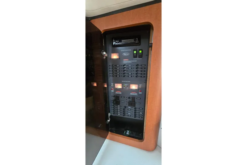 Slide: The Image of Electrical panel inside a 2005 Chaparral Signature 350 boat, featuring switches and controls. - 27