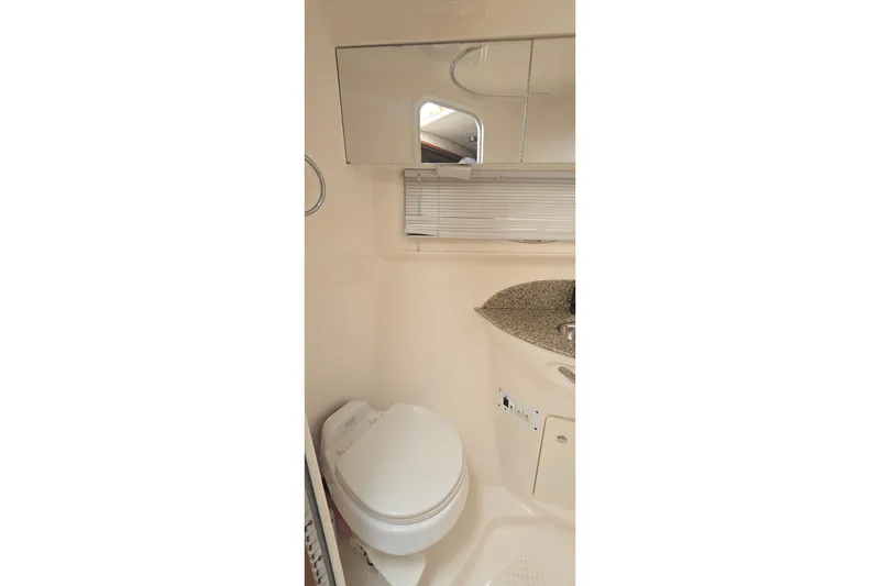 Slide: The Image of 2005 Chaparral Signature 350 bathroom interior with toilet, sink, and mirror. - 29