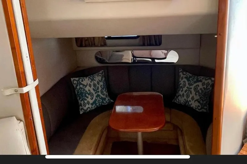 Slide: The Image of 2005 Chaparral Signature 350 cabin interior with cozy seating and wooden table. - 32