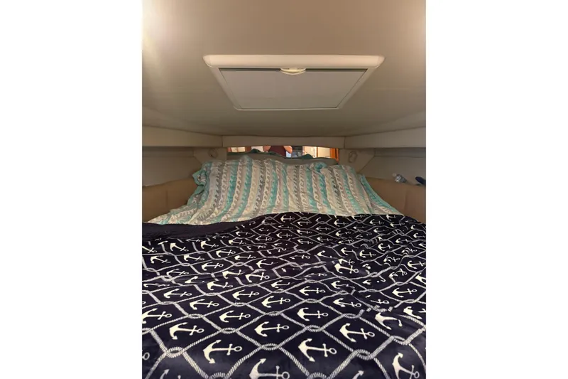 Slide: The Image of Interior cabin of 2005 Chaparral Signature 350 with nautical-themed bedding. - 33
