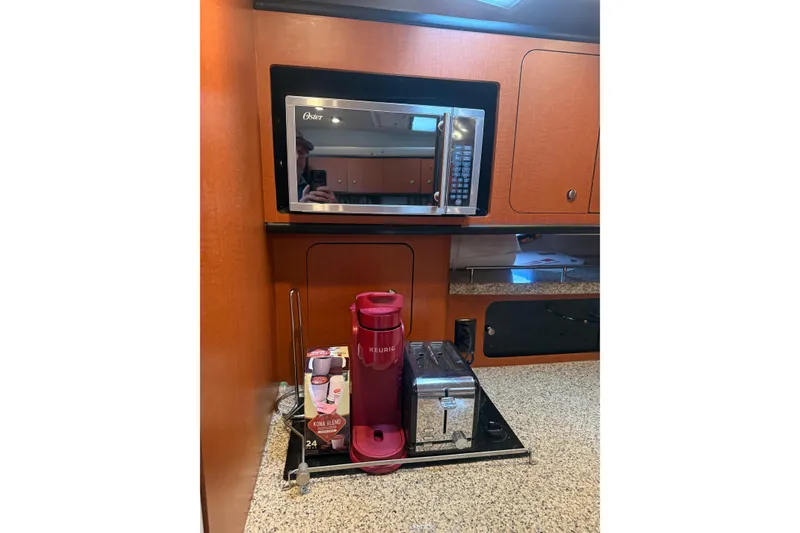 Slide: The Image of 2005 Chaparral Signature 350 kitchen with microwave, Keurig coffee maker, and toaster. - 38