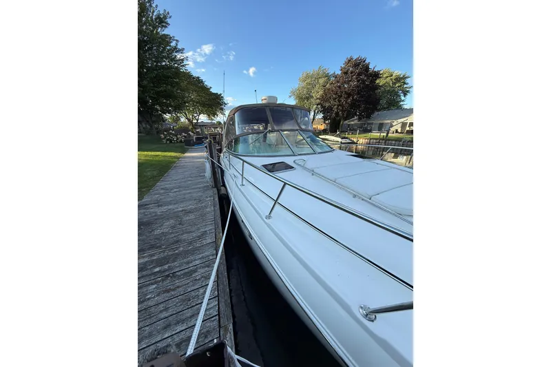Slide: The Image of Chaparral Signature 350 boat docked, 2005 model, with clear blue sky and trees in background. - 4