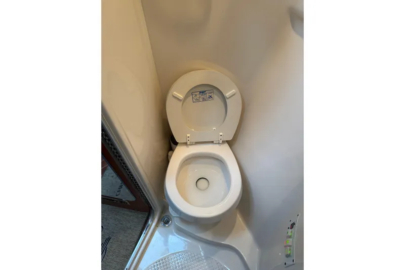 Slide: The Image of 2005 Chaparral Signature 350 boat bathroom with white toilet and compact design. - 42