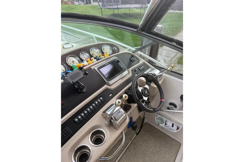 Slide: The Image of 2005 Chaparral Signature 350 boat dashboard with steering wheel and control panel. - 9