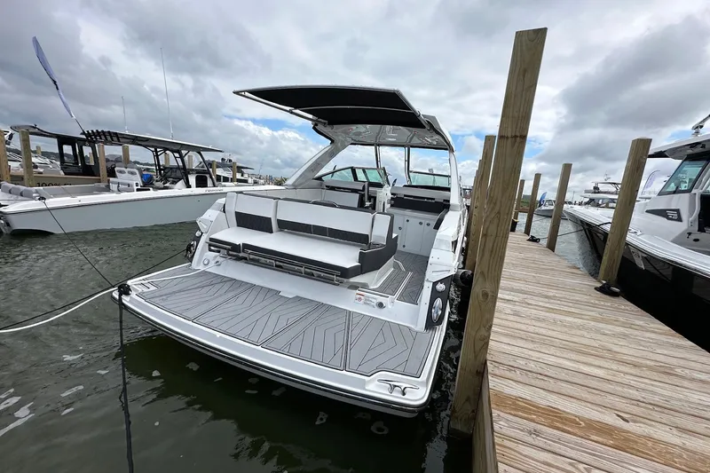 Slide: The Image of 2022 Monterey 378SS Super Sport boat docked, showcasing sleek design and spacious seating. - 2
