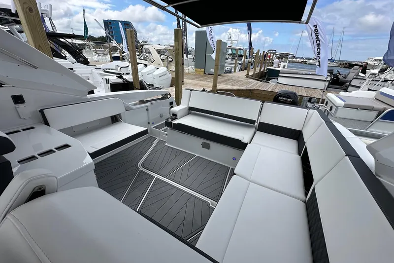Slide: The Image of 2022 Monterey 378SS Super Sport boat interior with luxurious seating at a marina. - 5
