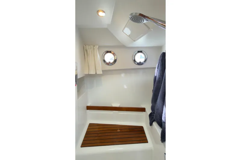 Slide: The Image of Bathroom interior of 2016 Beneteau Swift Trawler 30 with shower and wooden seat. - 12