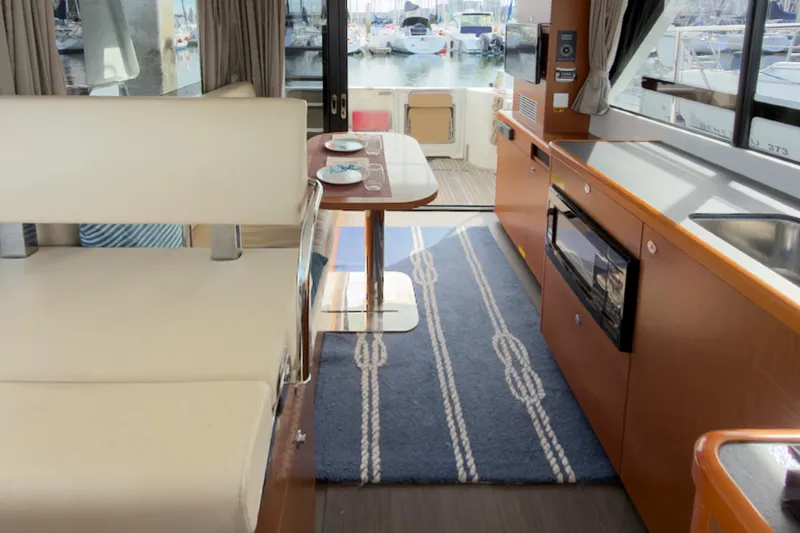 Slide: The Image of Interior of 2016 Beneteau Swift Trawler 30 with modern kitchen and dining area. - 13