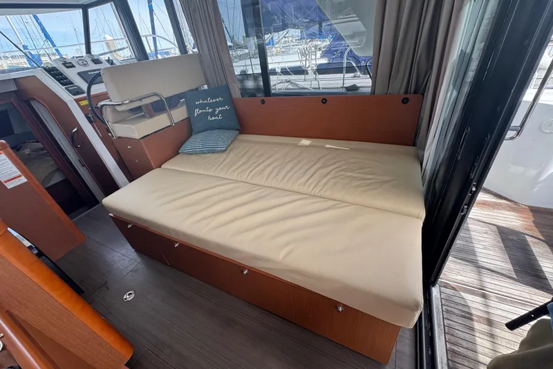 Slide: The Image of Interior of 2016 Beneteau Swift Trawler 30 with beige seating and nautical decor. - 19