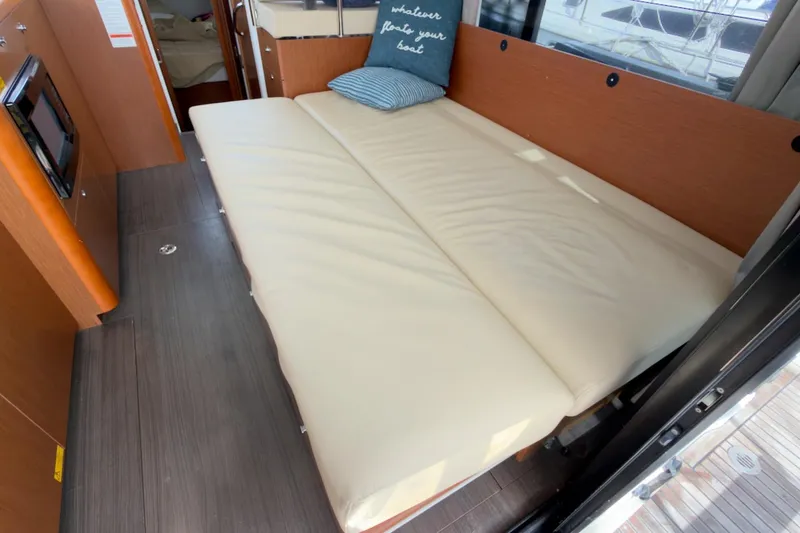 Slide: The Image of 2016 Beneteau Swift Trawler 30 interior with convertible sofa bed and nautical decor. - 20