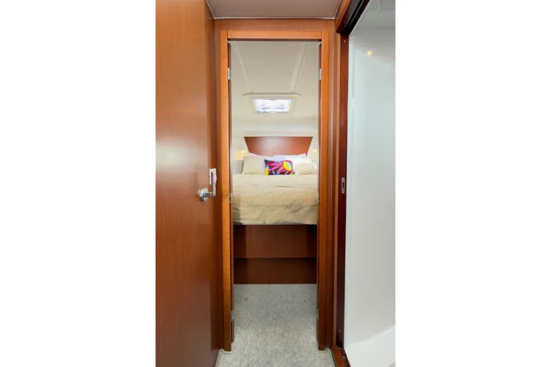 Slide: The Image of Interior cabin view of a 2016 Beneteau Swift Trawler 30, featuring a cozy bed. - 24