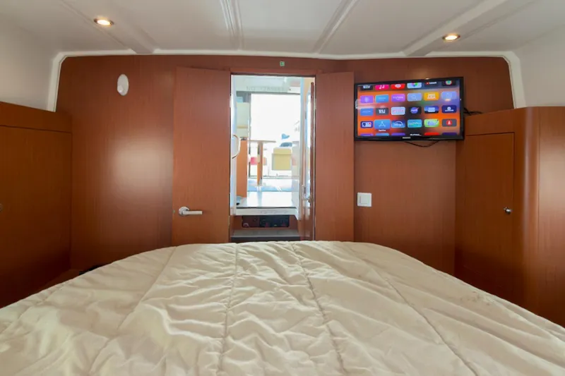 Slide: The Image of Interior of 2016 Beneteau Swift Trawler 30 with bed and mounted TV. - 26