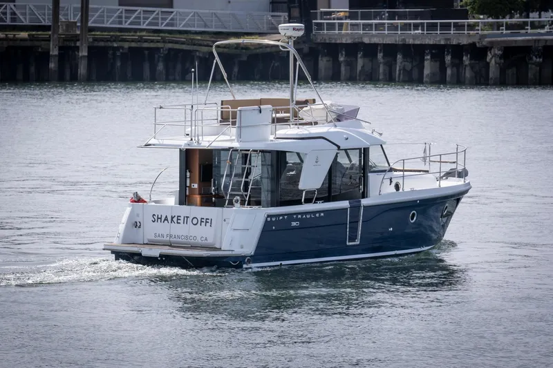 Slide: The Image of 2016 Beneteau Swift Trawler 30 cruising in a harbor, named "Shake It Off," San Francisco. - 3