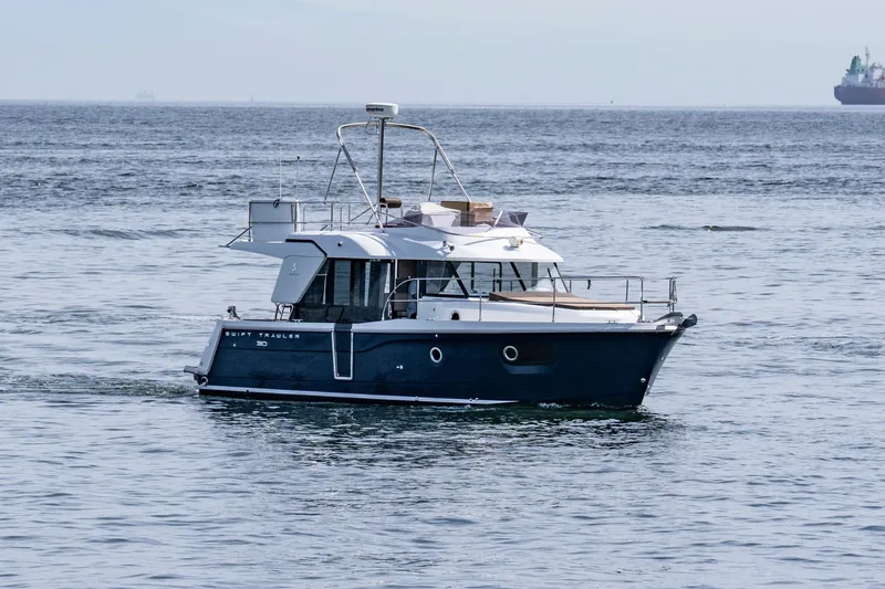 Slide: The Image of 2016 Beneteau Swift Trawler 30 cruising on open water. - 4