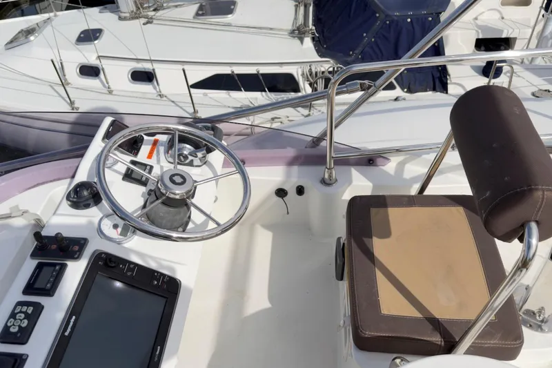 Slide: The Image of Helm station of 2016 Beneteau Swift Trawler 30 with steering wheel and navigation equipment. - 43