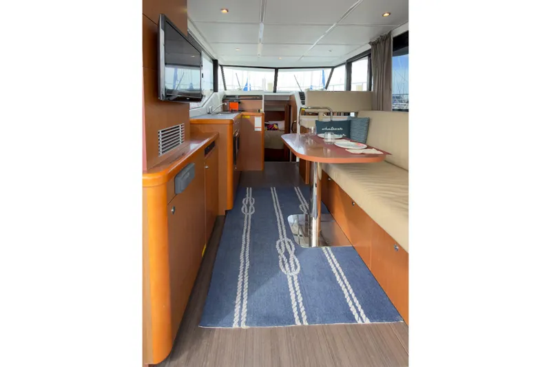Slide: The Image of Interior of 2016 Beneteau Swift Trawler 30 with cozy seating and nautical decor. - 8