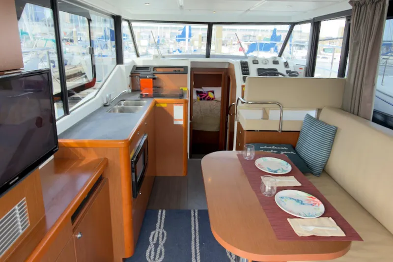 Slide: The Image of Interior of 2016 Beneteau Swift Trawler 30 with dining area and helm station. - 9