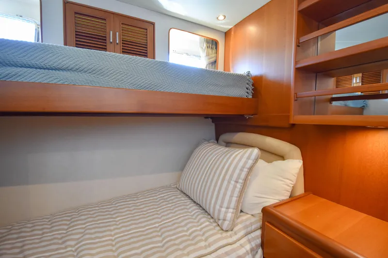 Slide: The Image of Cozy cabin interior of 2013 Fleming 55 yacht with bunk beds and wooden furnishings. - 10