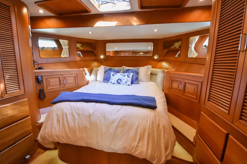 Slide: The Image of Luxurious 2013 Fleming 55 yacht bedroom with elegant wood finish and cozy bedding. - 14