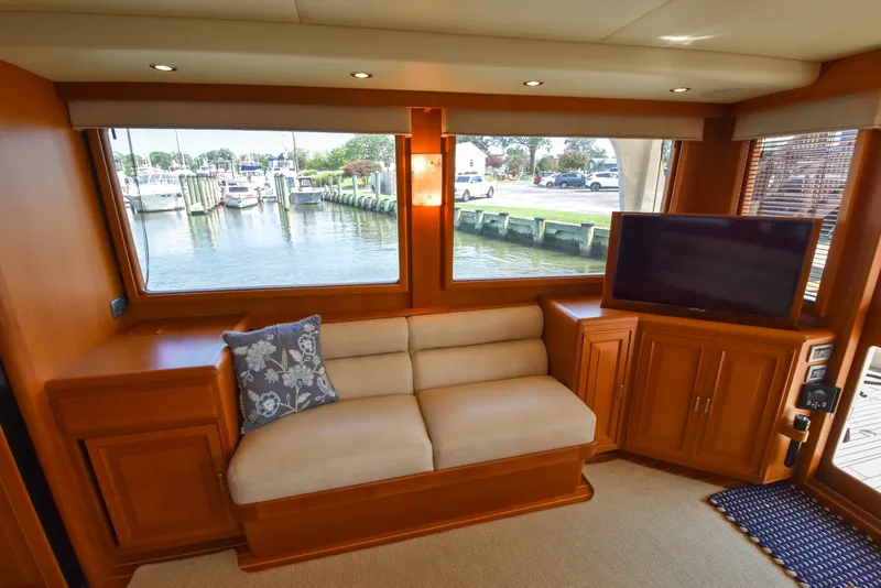 Slide: The Image of Luxurious interior of 2013 Fleming 55 yacht with sofa, TV, and marina view. - 2