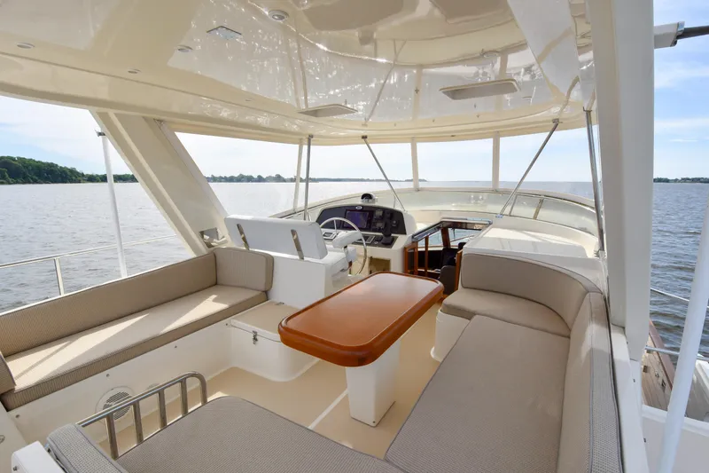Slide: The Image of Luxurious 2013 Fleming 55 yacht interior with spacious seating and helm, overlooking serene waters. - 24