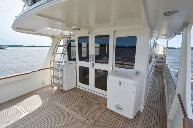Slide: The Image of Fleming 55 yacht deck, 2013 model, featuring teak flooring and ocean view. - 28