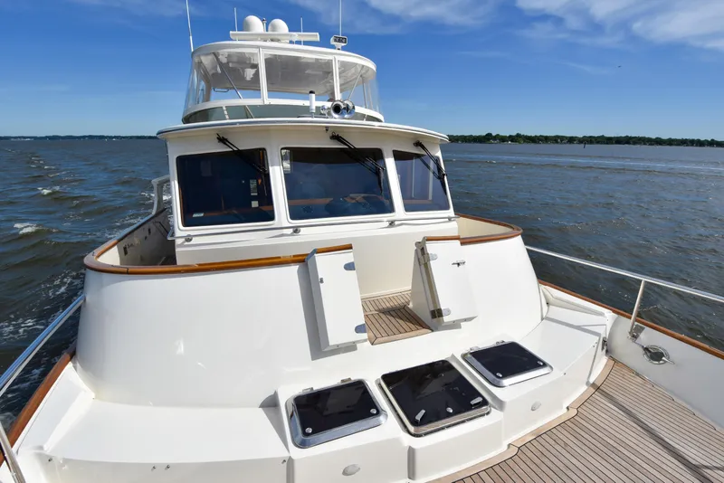 Slide: The Image of Fleming 55 yacht cruising on open water, showcasing sleek design and spacious deck. - 31