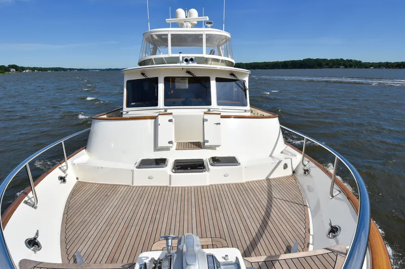 Slide: The Image of 2013 Fleming 55 yacht cruising on a sunny day, showcasing spacious deck and sleek design. - 33