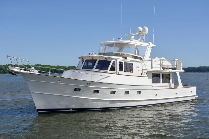 Slide: The Image of 2013 Fleming 55 yacht cruising on a calm lake under a clear blue sky. - 34