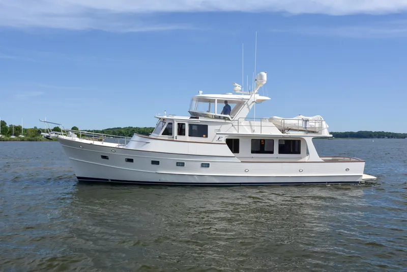 Slide: The Image of 2013 Fleming 55 yacht cruising on a calm lake under a clear blue sky. - 38
