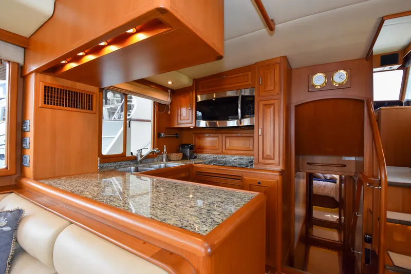 Slide: The Image of Luxurious 2013 Fleming 55 yacht interior with modern kitchen and wooden cabinetry. - 5