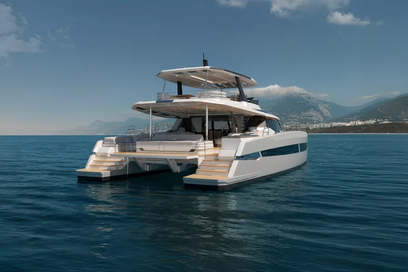 Slide: The Image of Luxurious 2027 Fountaine Pajot FPY 70 catamaran on serene ocean waters, with mountainous backdrop. - 20