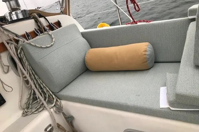 Slide: The Image of Cozy seating area on 1989 Freedom 38 Sloop sailboat with ropes and cushion. - 15