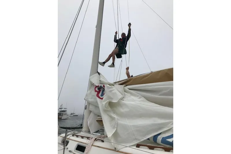Slide: The Image of Person climbing mast on 1989 Freedom 38 Sloop sailboat, adjusting sails. - 18
