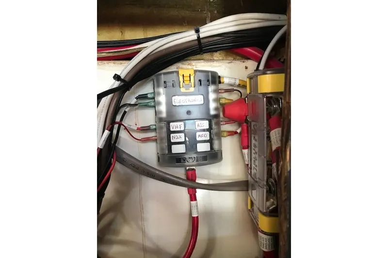 Slide: The Image of Electrical panel with labeled wires on a 1989 Freedom 38 Sloop sailboat. - 25