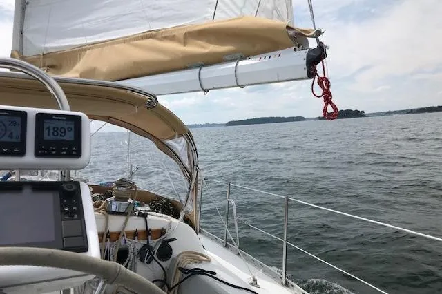 Slide: The Image of 1989 Freedom 38 Sloop sailing on open water with visible navigation instruments. - 26