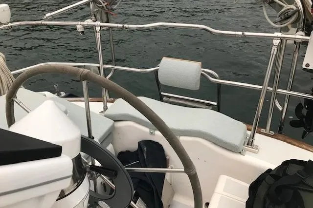 Slide: The Image of Cockpit of 1989 Freedom 38 Sloop with steering wheel and cushioned seating. - 29