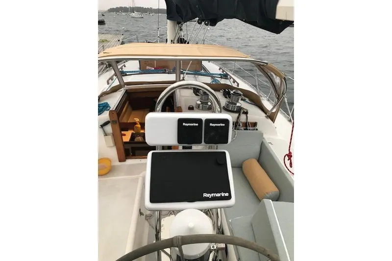 Slide: The Image of 1989 Freedom 38 Sloop cockpit with Raymarine navigation, sailing on a calm sea. - 30