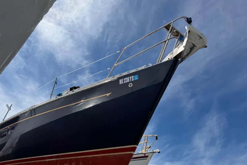 Slide: The Image of 1989 Freedom 38 Sloop sailboat with blue hull against a clear sky. - 44