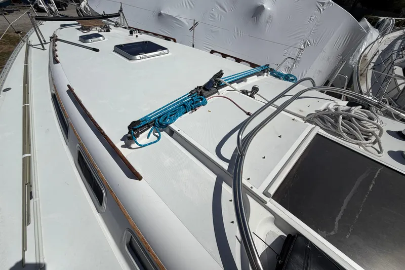 Slide: The Image of 1989 Freedom 38 Sloop deck with ropes and hatches, showcasing sailing equipment. - 47