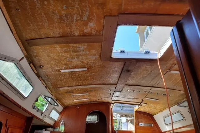 Slide: The Image of Interior view of 1989 Freedom 38 Sloop sailboat, showing wooden ceiling and open hatch. - 5