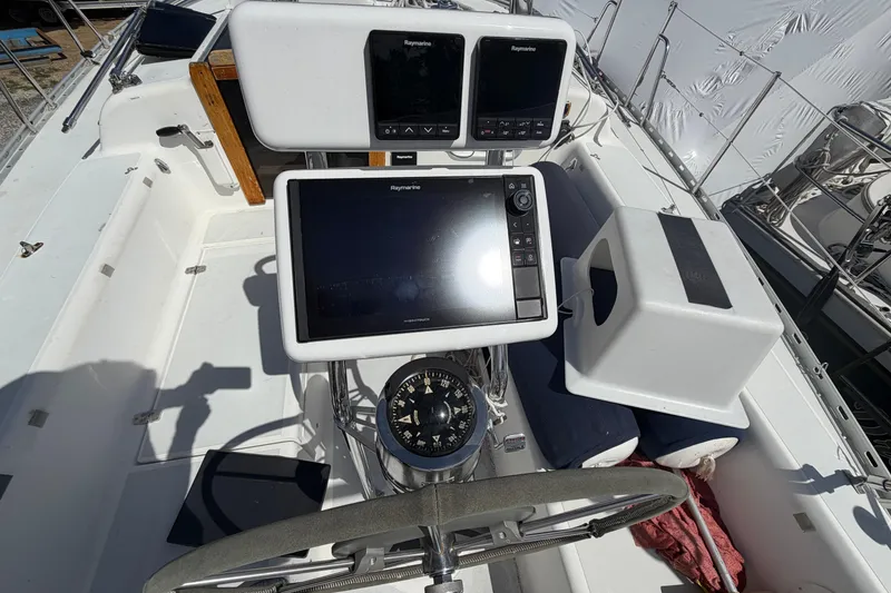 Slide: The Image of Cockpit of 1989 Freedom 38 Sloop with navigation equipment and steering wheel. - 52
