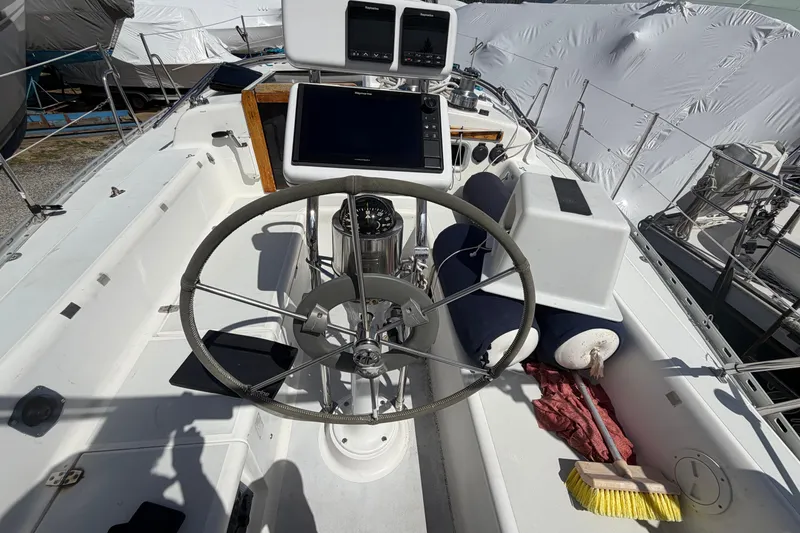Slide: The Image of Cockpit of 1989 Freedom 38 Sloop with steering wheel and navigation equipment. - 54