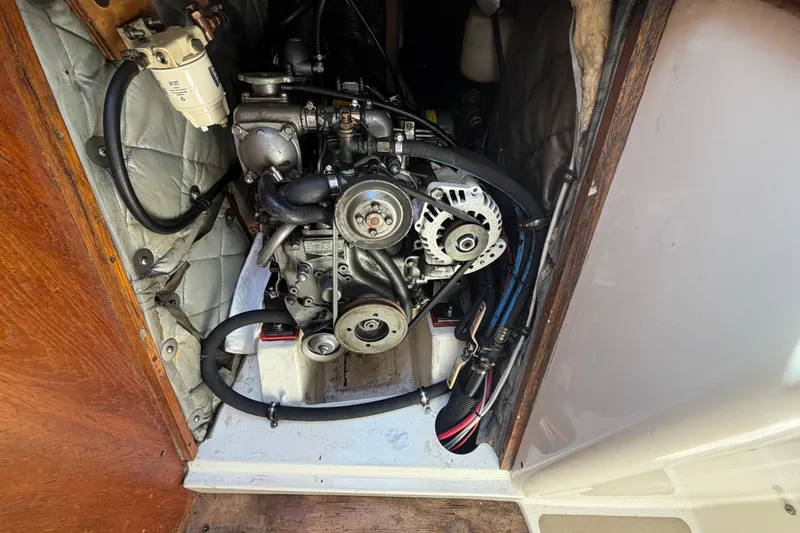 Slide: The Image of Engine compartment of a 1989 Freedom 38 Sloop sailboat, showcasing mechanical components. - 58