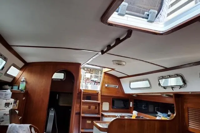 Slide: The Image of Interior of 1989 Freedom 38 Sloop sailboat with wooden cabinetry and skylight. - 6